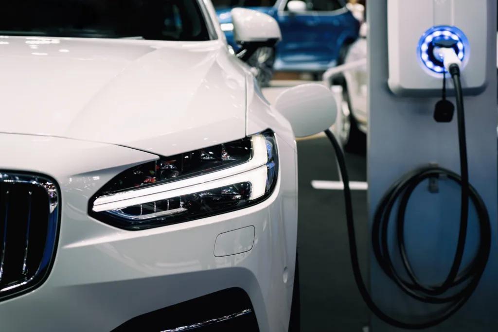 Power,Supply,For,Hybrid,Electric,Car,Charging,Battery.,Eco,Car EV Charge station charging a white sedan